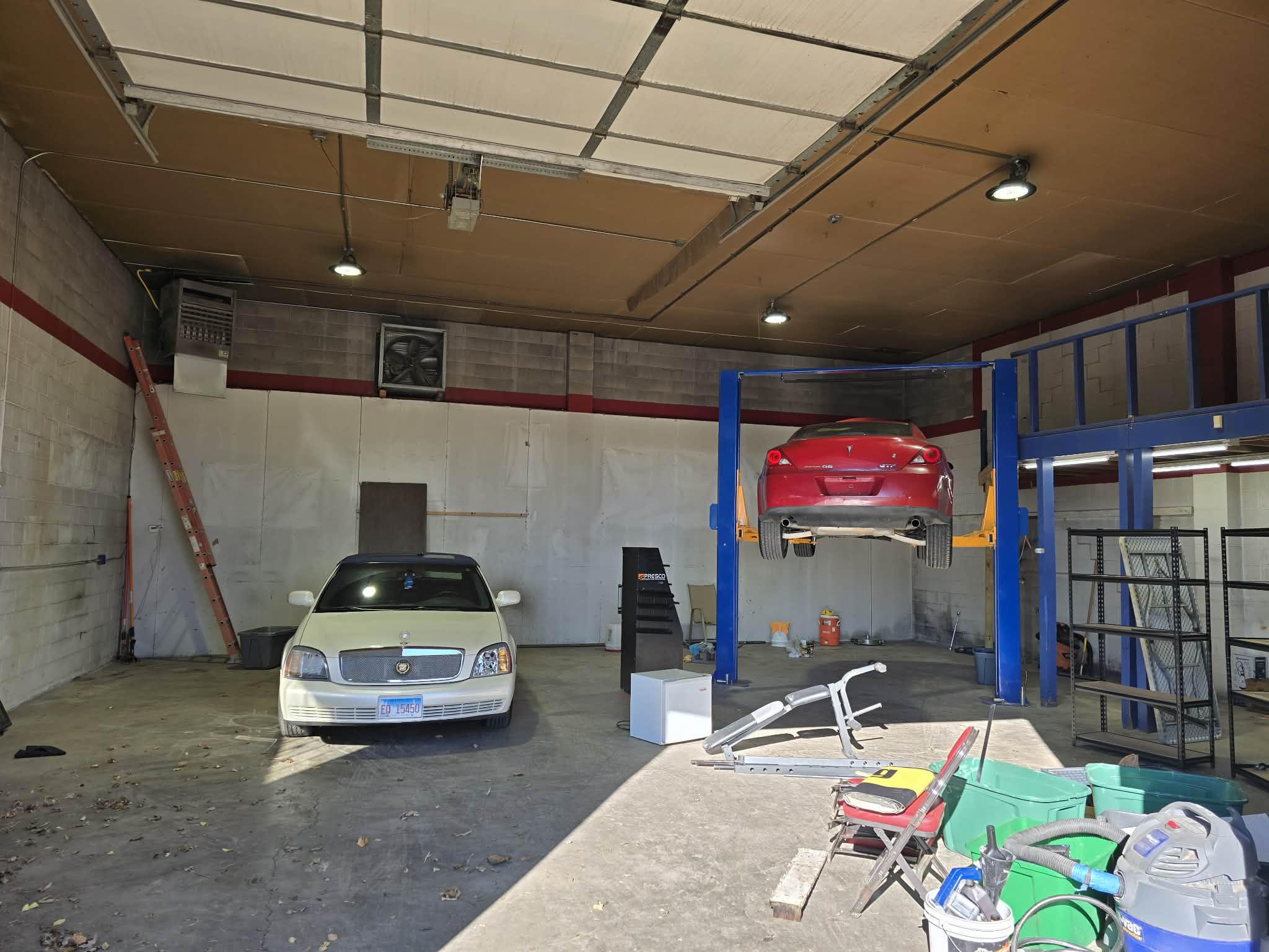 Tintman Auto Care and Sound Solutions shop interior with professional lift and workspace